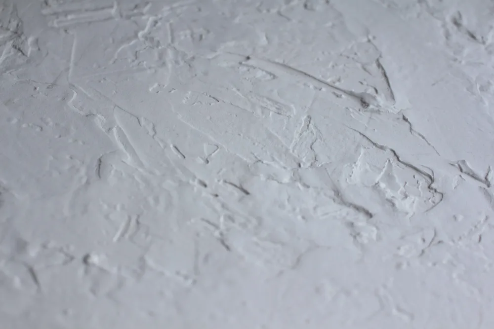 Close-up of a textured plaster wall.